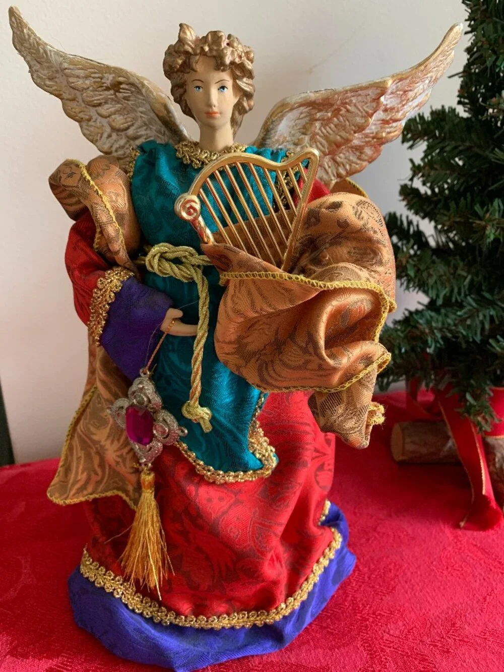 Vintage 10 inch decorative angel figurine with jewel tone clothing and gold harp